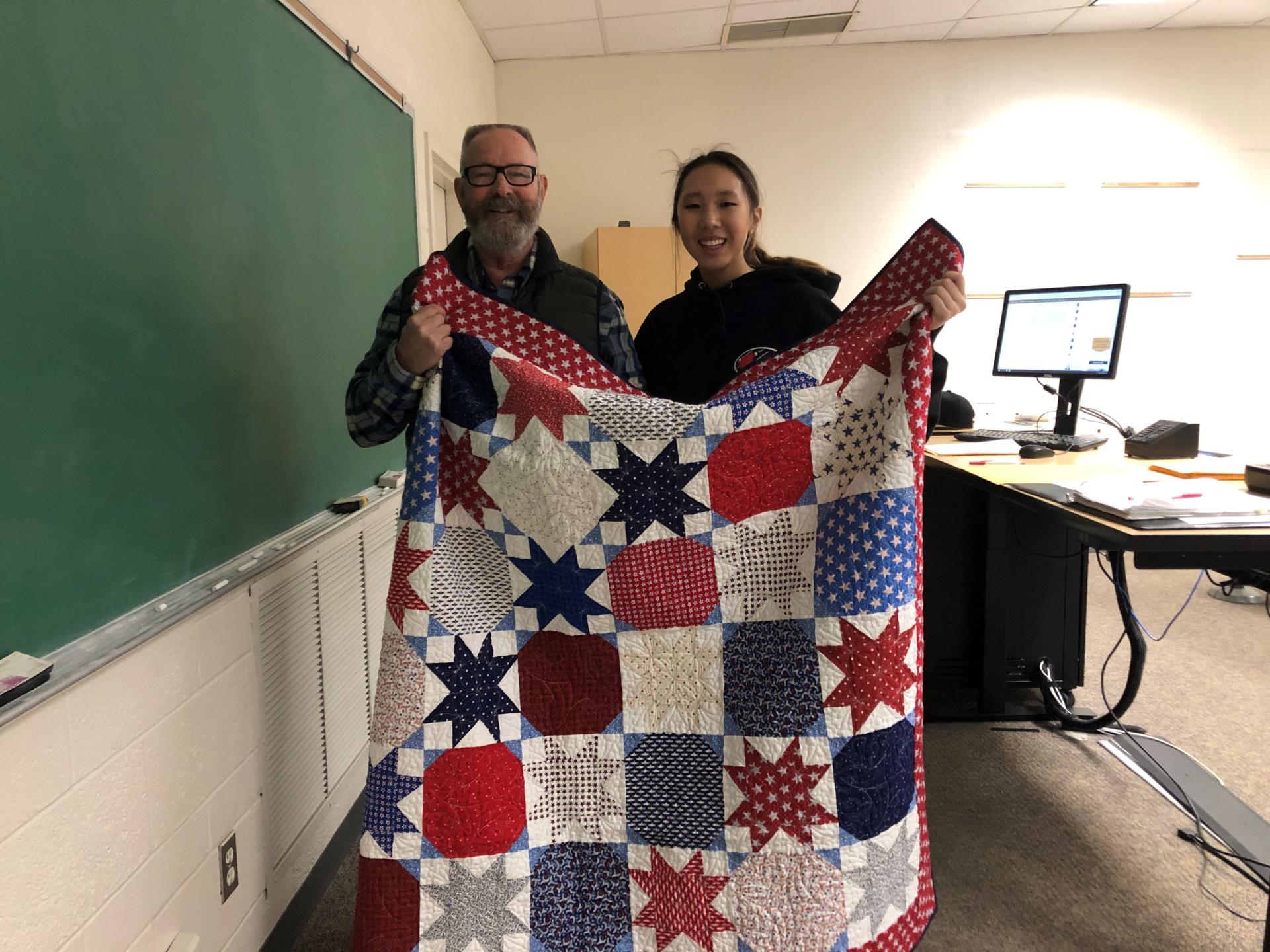 Bede Bolin and student with quilt