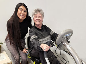 Two people with stationary bike