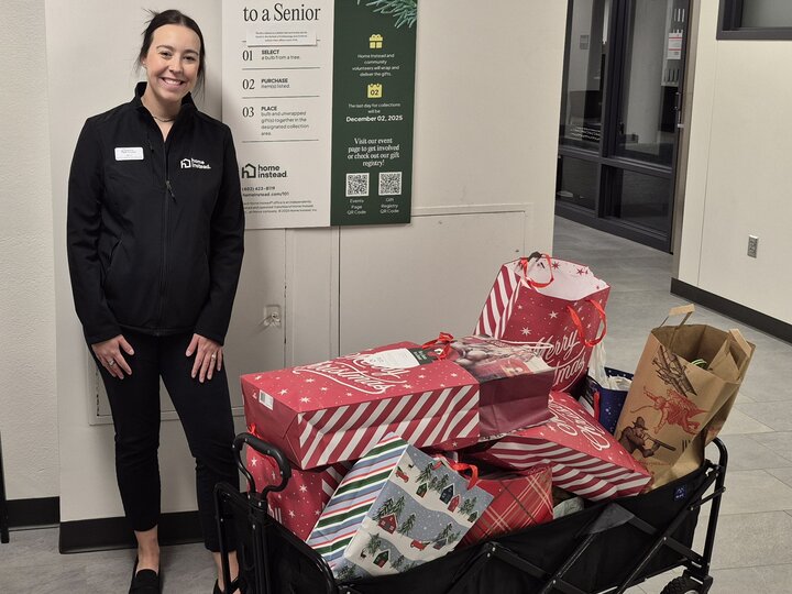 Bradi from Home Instead pictured with Santa to a Senior Gifts